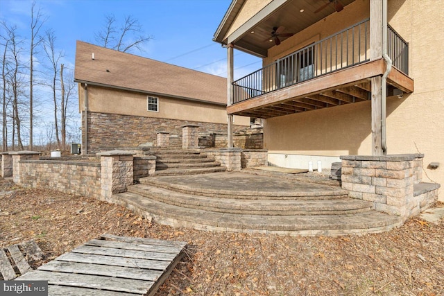 exterior space with ceiling fan and a patio