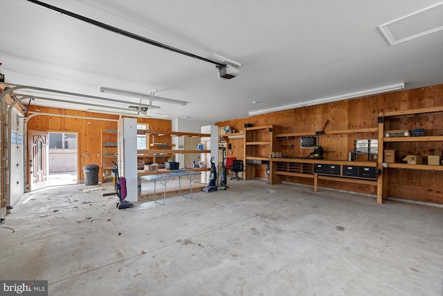 garage with a workshop area and a garage door opener