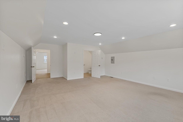 interior space featuring light colored carpet and lofted ceiling