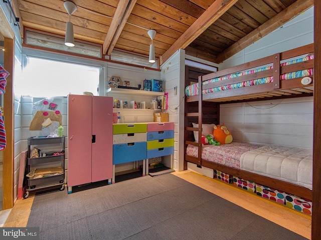 bedroom featuring wooden walls, wooden ceiling, vaulted ceiling, and light hardwood / wood-style floors