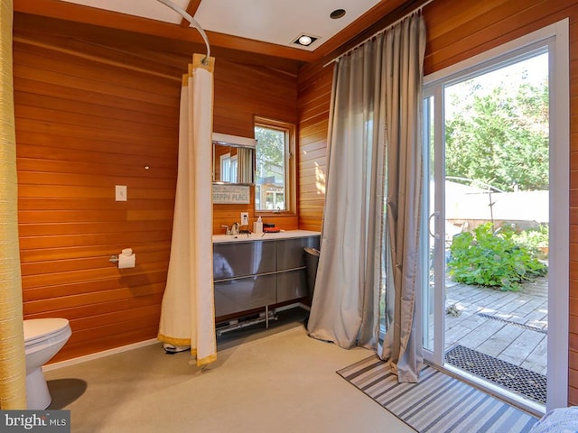 doorway to outside with wooden walls and plenty of natural light