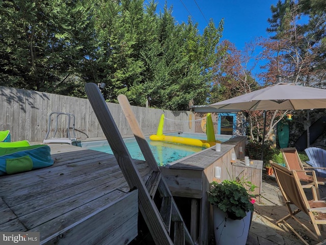 deck with a fenced in pool