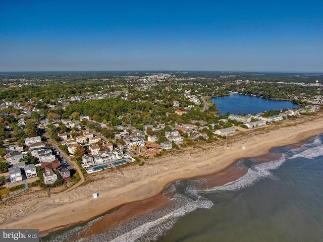 bird's eye view featuring a view of the beach and a water view