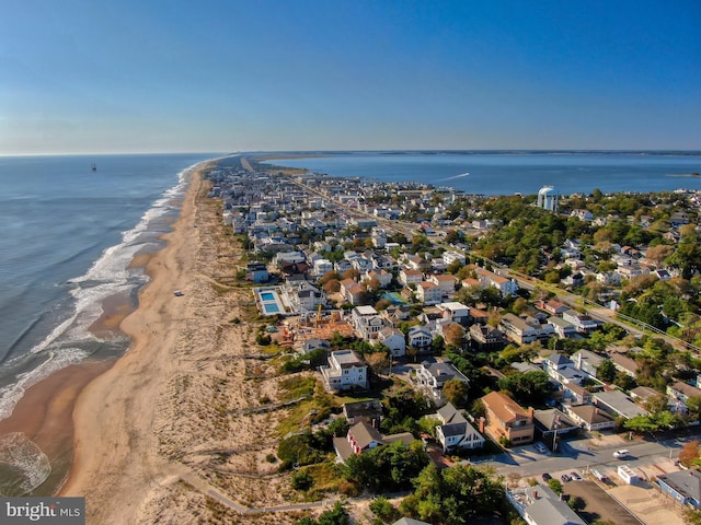 aerial view with a water view and a beach view