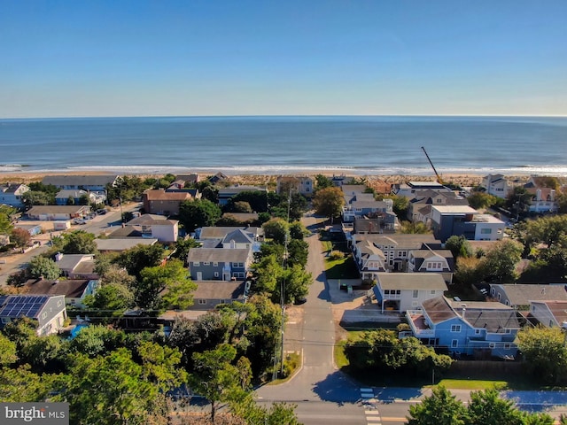 drone / aerial view with a water view and a beach view