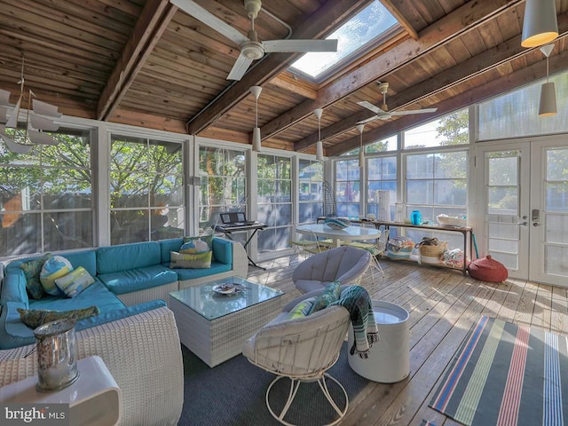 sunroom / solarium featuring french doors, ceiling fan, wood ceiling, and vaulted ceiling with skylight