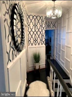 interior space featuring an inviting chandelier and ornamental molding