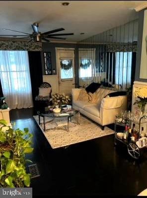 living room with ceiling fan and hardwood / wood-style flooring