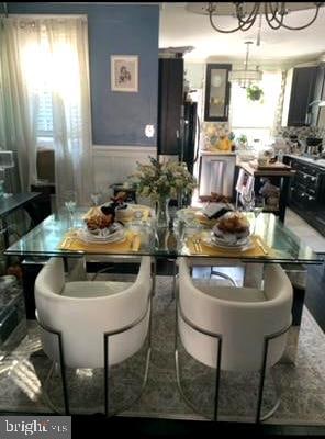 dining area featuring a notable chandelier and a wealth of natural light