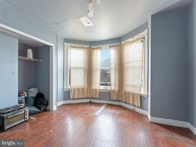 empty room featuring ceiling fan and dark wood-type flooring