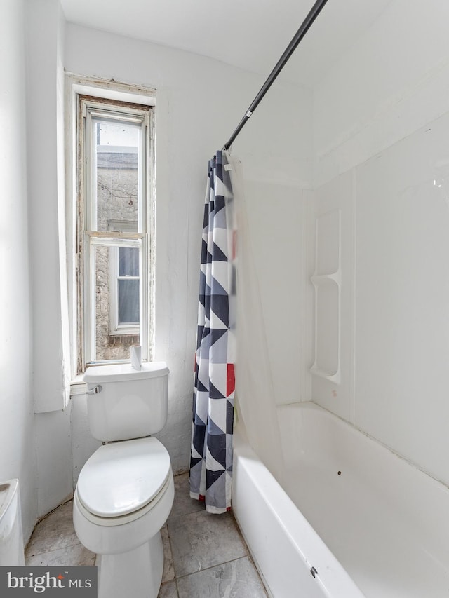 bathroom featuring tile flooring, toilet, and shower / bath combo