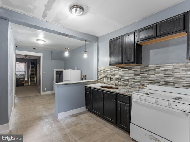 kitchen featuring hanging light fixtures, ceiling fan, white appliances, sink, and tasteful backsplash