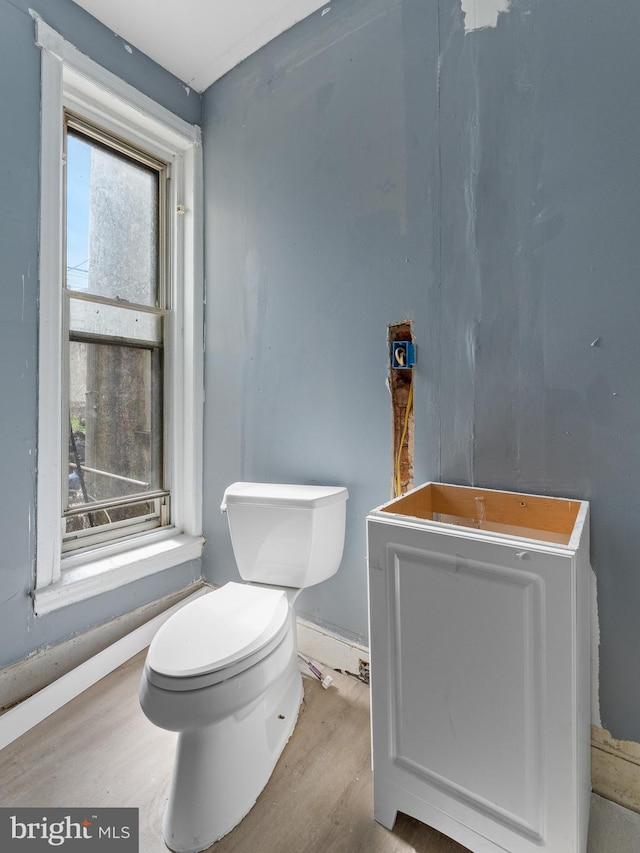 bathroom with toilet and hardwood / wood-style floors