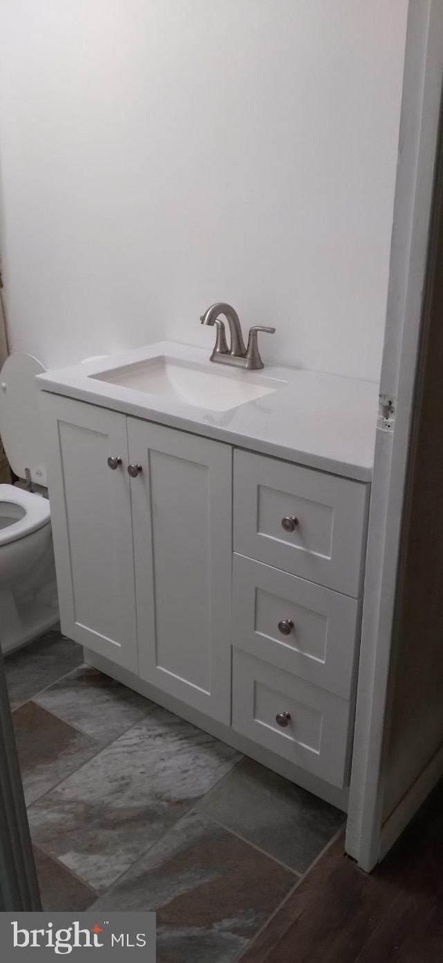 bathroom featuring vanity and toilet