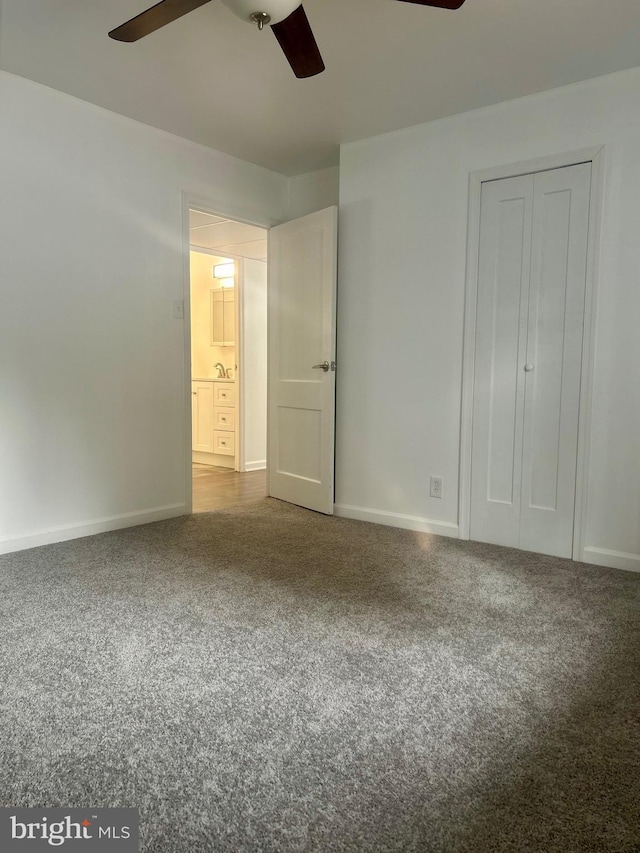 unfurnished bedroom with ceiling fan, carpet floors, and a closet