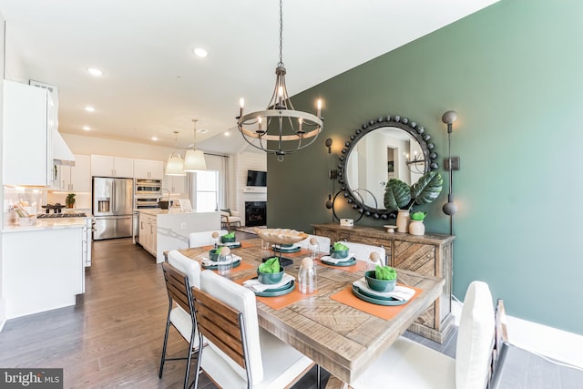 dining space with dark hardwood / wood-style floors and a chandelier