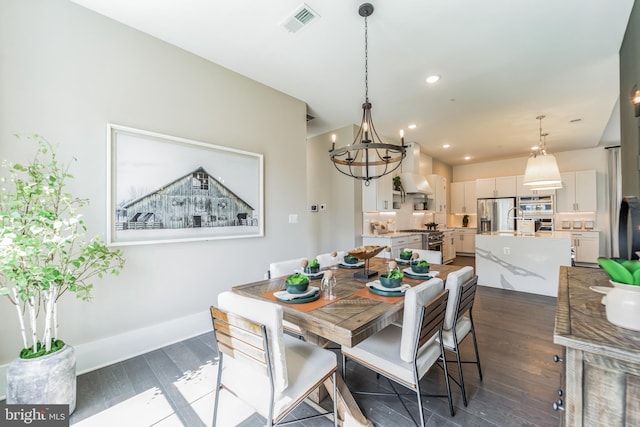 dining area featuring dark hardwood / wood-style flooring and a notable chandelier