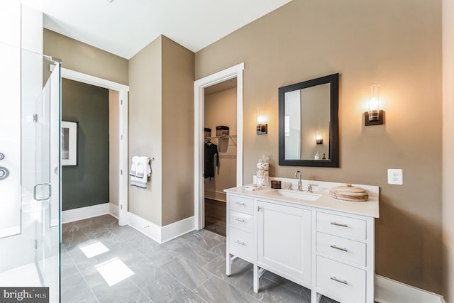 bathroom featuring vanity with extensive cabinet space, tile floors, and walk in shower