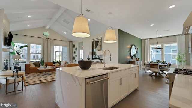 kitchen featuring hanging light fixtures, a healthy amount of sunlight, appliances with stainless steel finishes, and light stone counters