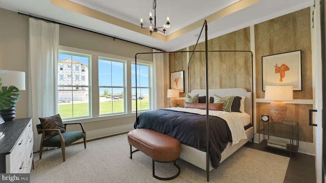 bedroom with a notable chandelier and light wood-type flooring