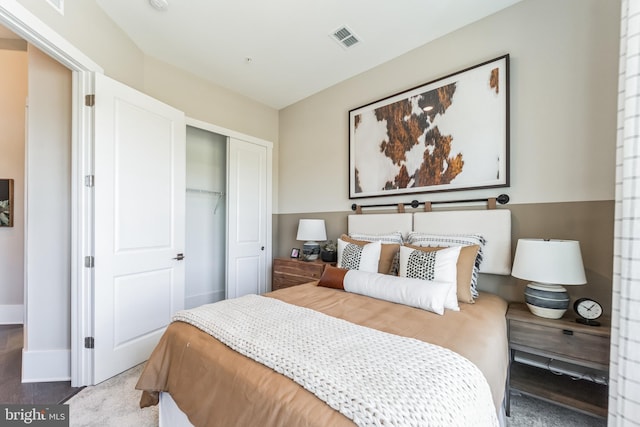 bedroom featuring a closet and dark colored carpet