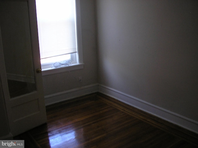 unfurnished room featuring dark hardwood / wood-style floors