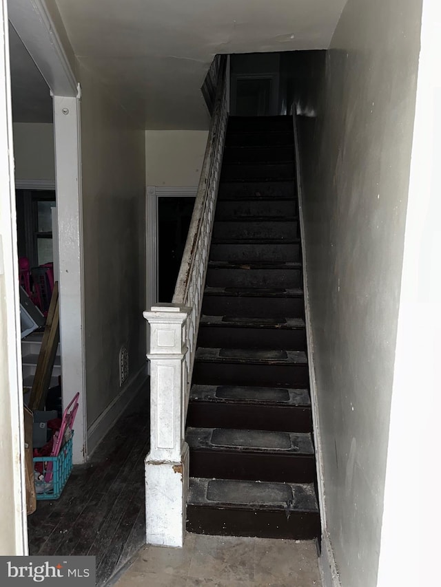 stairway with wood-type flooring