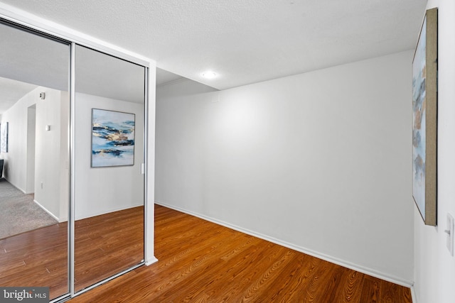 unfurnished bedroom featuring light carpet and a closet