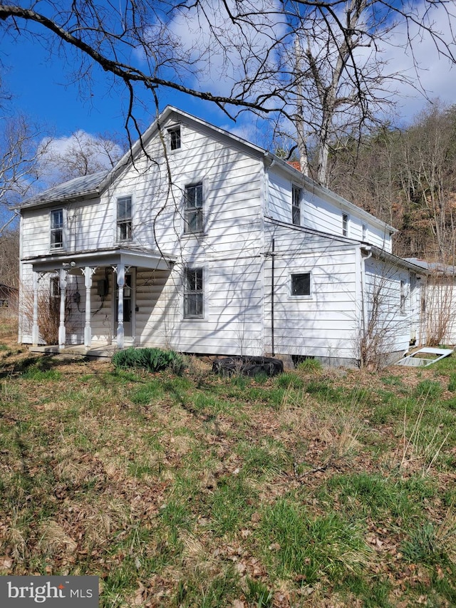 back of house featuring a porch