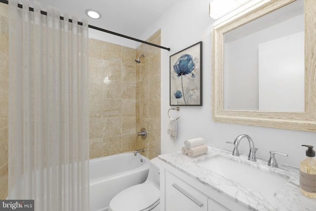 full bathroom with vanity, toilet, and tiled shower / bath