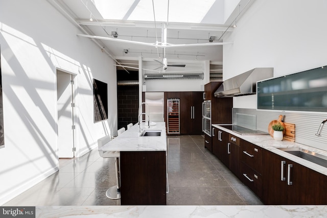 kitchen featuring sink, a kitchen island, pendant lighting, and a breakfast bar