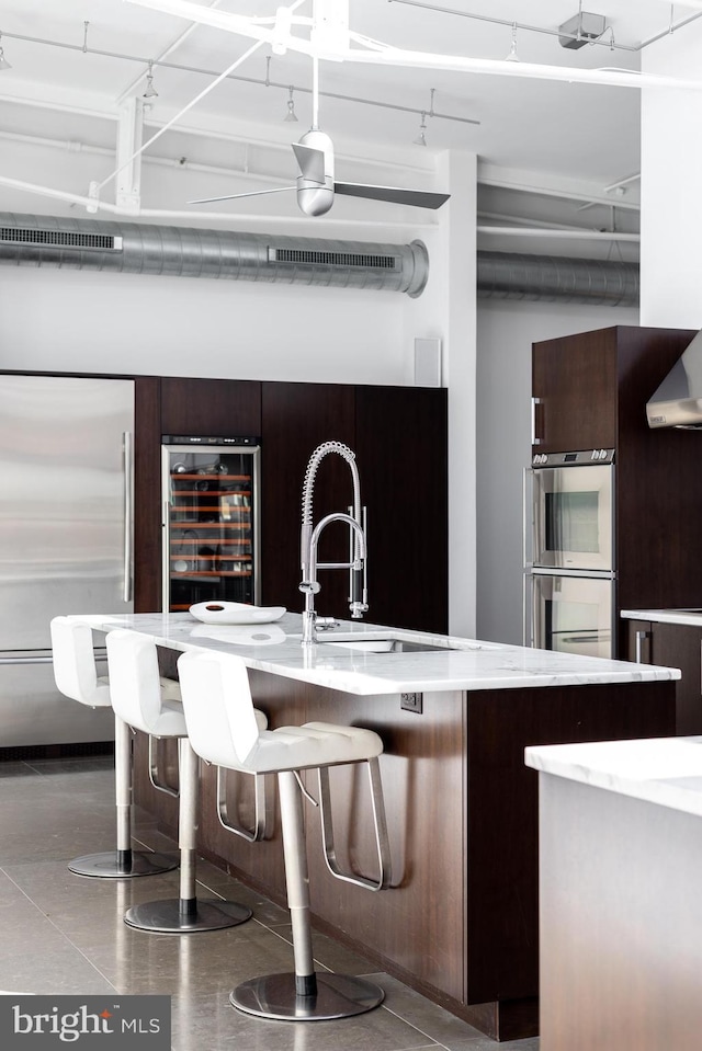 kitchen featuring appliances with stainless steel finishes and beverage cooler