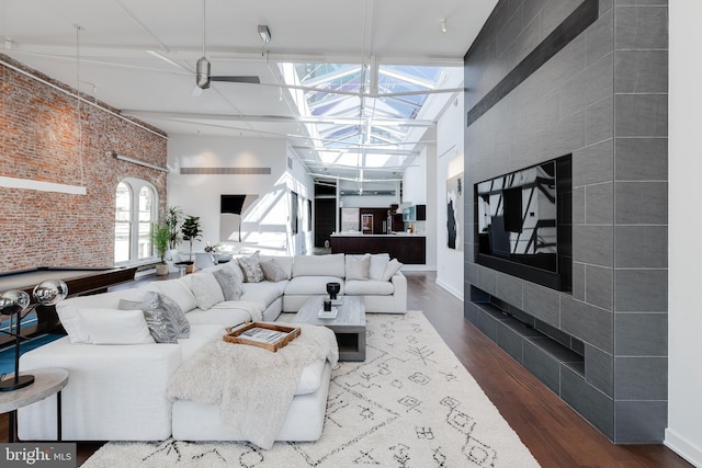 living room featuring billiards, a high ceiling, and hardwood / wood-style floors