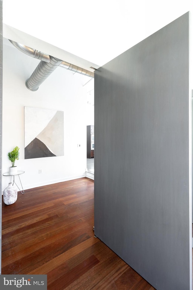 hall with dark hardwood / wood-style flooring