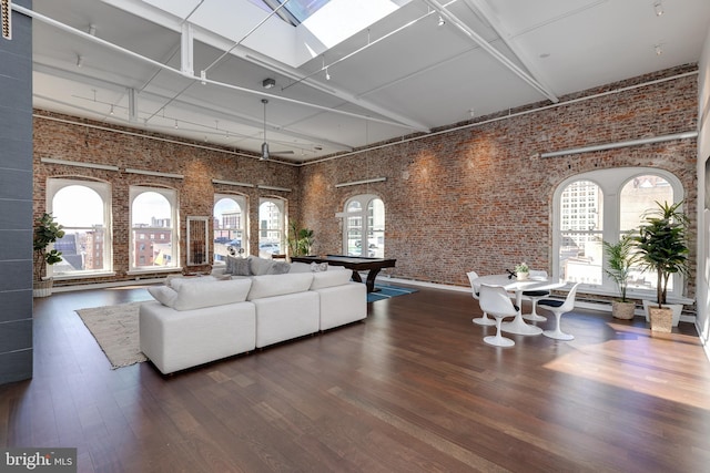 living room featuring pool table, dark hardwood / wood-style floors, high vaulted ceiling, and a wealth of natural light