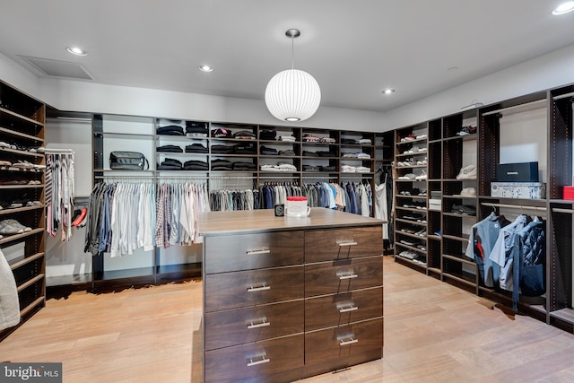 walk in closet with light wood-type flooring