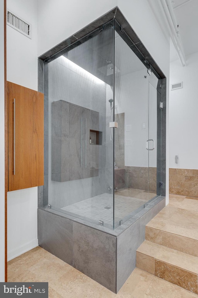 bathroom with a shower with door