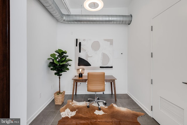 home office featuring dark tile patterned flooring