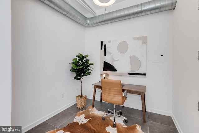 office area featuring dark tile patterned flooring