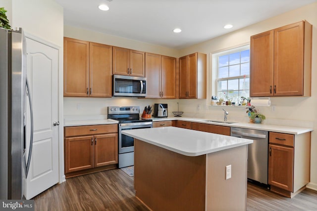 kitchen with a kitchen island, sink, stainless steel appliances, and dark hardwood / wood-style floors