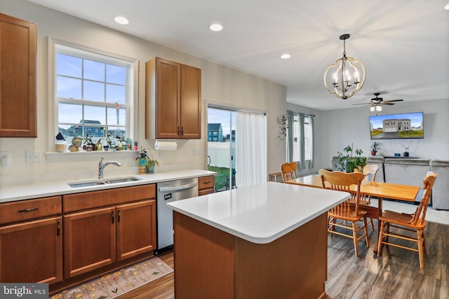 kitchen with a kitchen island, dishwasher, ceiling fan with notable chandelier, hanging light fixtures, and wood-type flooring