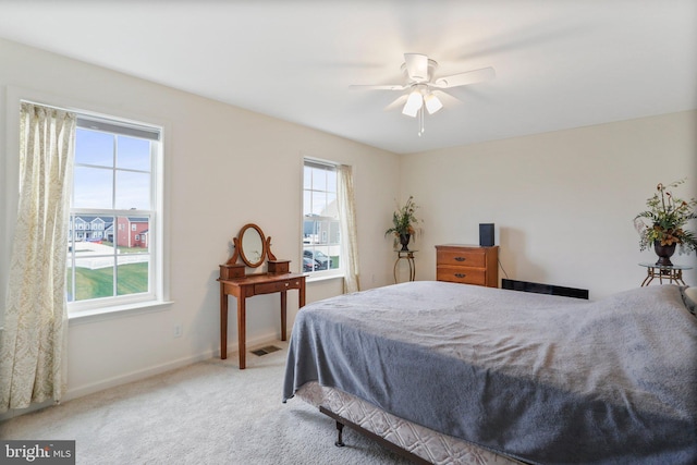 bedroom featuring light carpet and ceiling fan