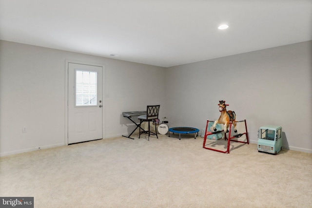 rec room with light colored carpet