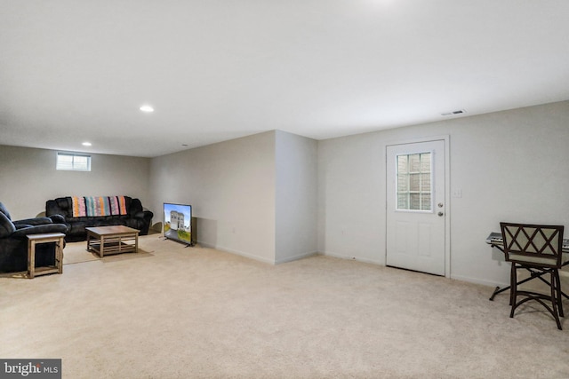 sitting room featuring light carpet