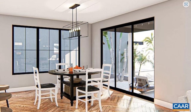 dining area featuring light parquet floors, a chandelier, and a wealth of natural light