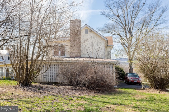 view of side of home with a yard