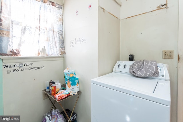 clothes washing area with washer / dryer and a healthy amount of sunlight