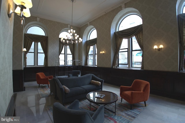 interior space featuring a notable chandelier, crown molding, a healthy amount of sunlight, and vaulted ceiling