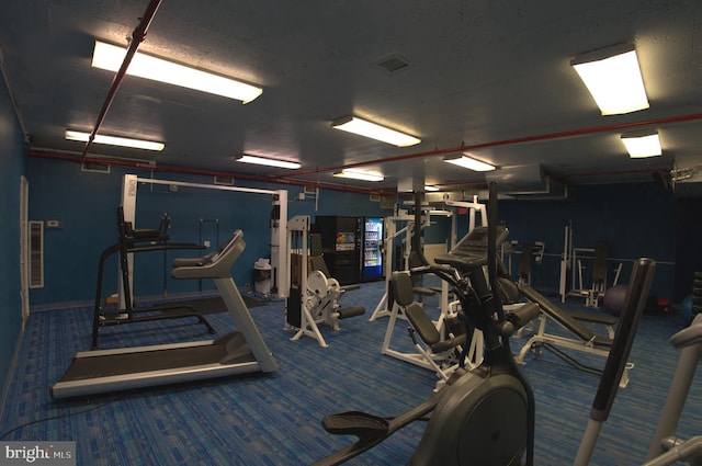 workout area with dark carpet