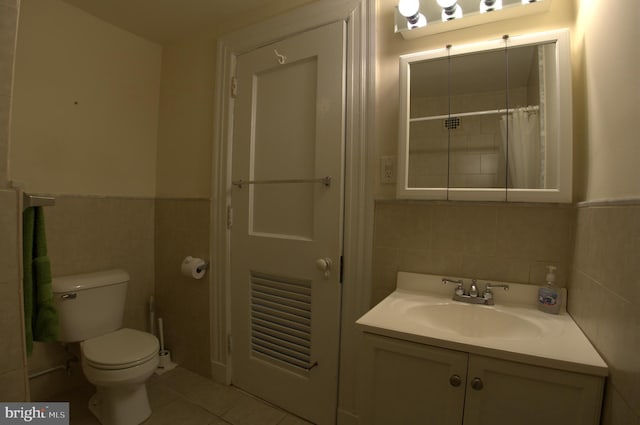 bathroom featuring vanity, tile walls, tile floors, toilet, and tasteful backsplash